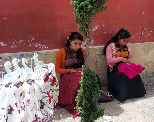 twee vrouwen die traditionele kleding borduren